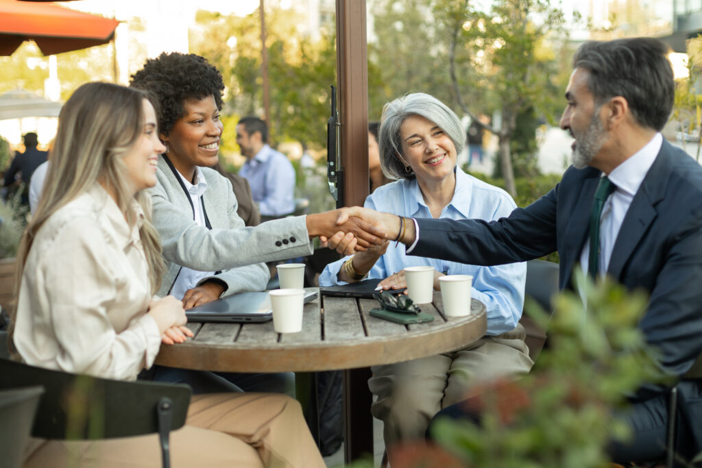 A customer retention strategist shaking hands with a client