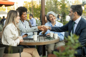 A customer retention strategist shaking hands with a client