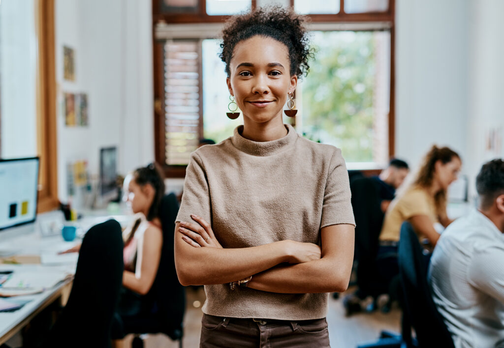 A confident sales and marketing intern crossing their arms