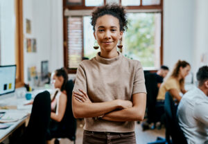 A confident sales and marketing intern crossing their arms